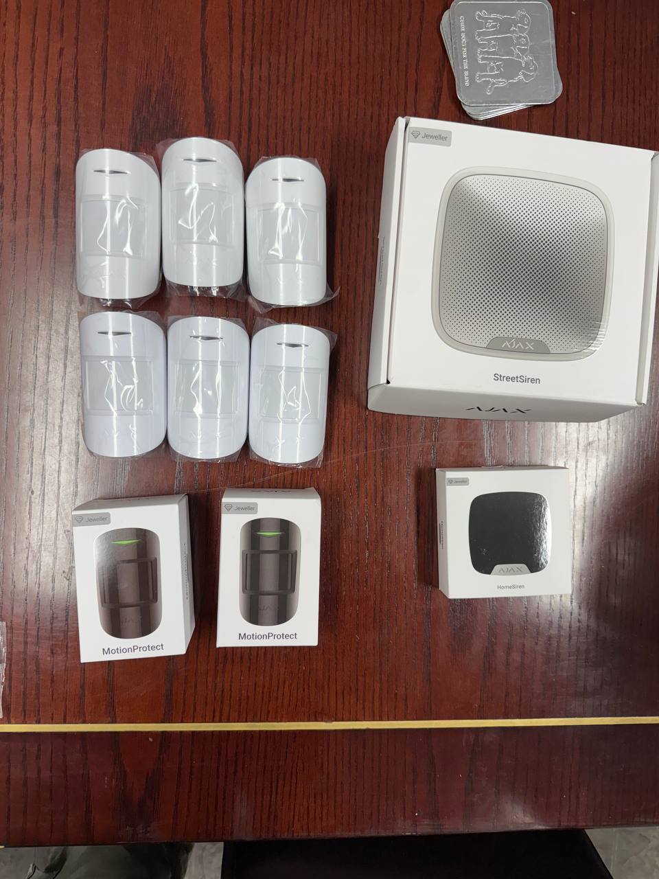 Installer working with an AJAX security camera on a brick wall