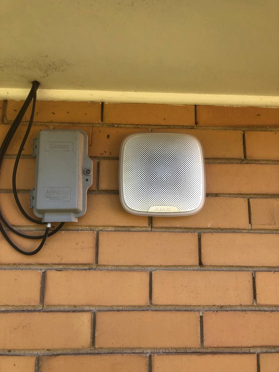 Outdoor camera and lighting mounted on a residential façade