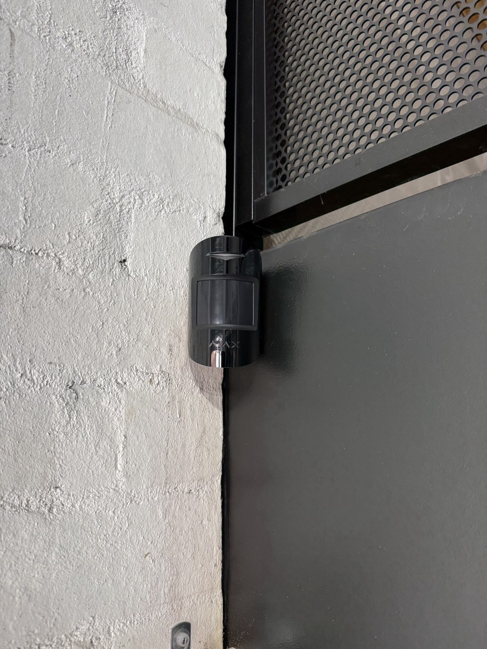 Ajax hub installed on wall next to light switch