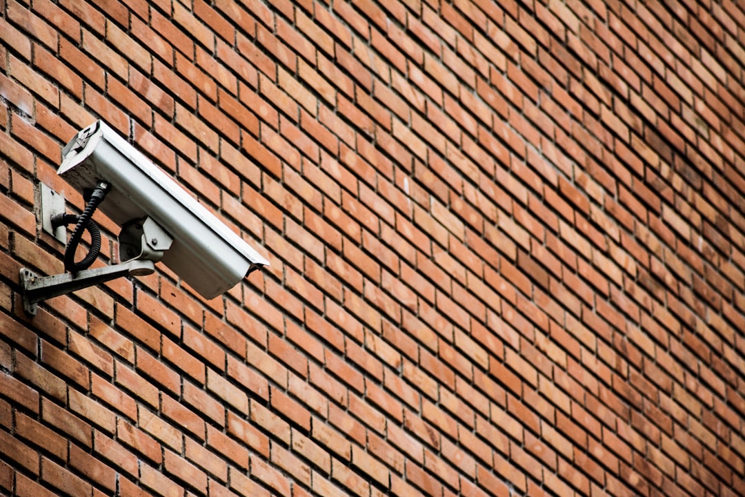 battery-solar-security-cameras-renters-wireless-camera-wall - SIPKO Security Wireless battery security camera mounted on an exterior brick wall with no cable run