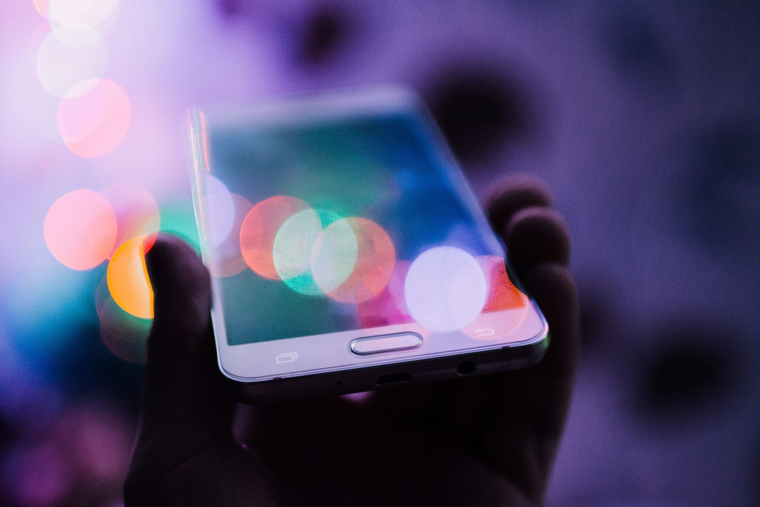 Hand holding a smartphone showing a security alert notification