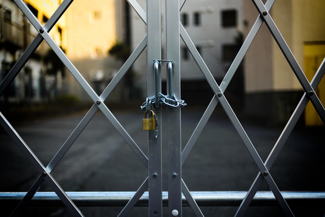 Steel security gate secured with a heavy-duty padlock at a commercial premises