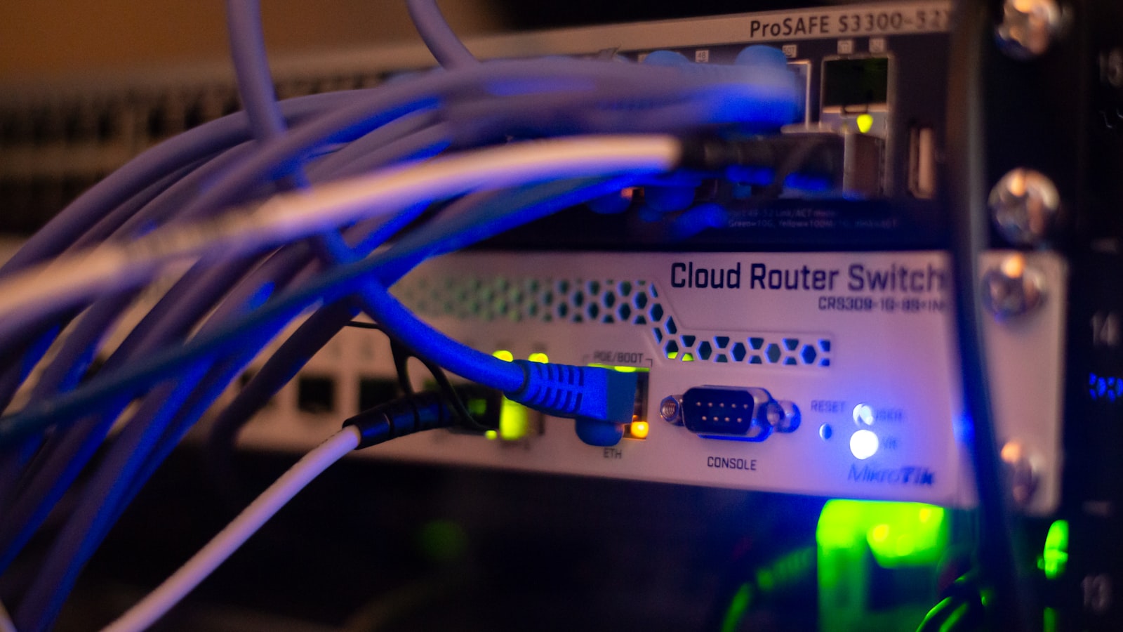 Network switch and ethernet cabling in a comms cabinet, the kind that feeds a commercial CCTV recorder