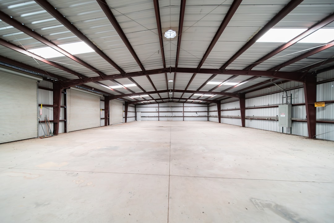 dahua-8mp-warehouse-coverage - SIPKO Security Large empty warehouse interior with steel roof trusses