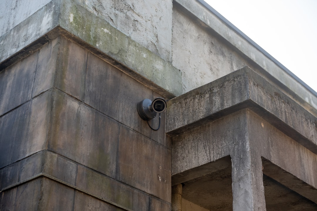 hardwired-poe-security-camera-homeowners-brand-comparison - SIPKO Security Security camera mounted on an exterior wall, one of three brands compared for homeowner hardwired PoE systems