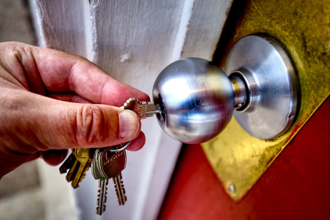 new-home-security-checklist-rekey-locks - SIPKO Security Close-up of a deadbolt lock and keyset being fitted to an exterior door