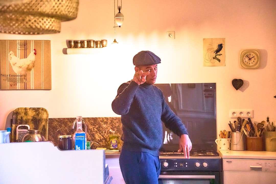 Older man on a phone call in his kitchen at home