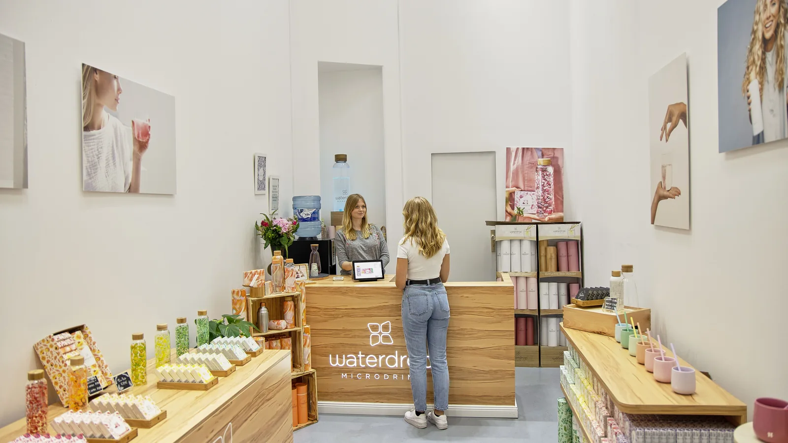 Small retail shop counter and product displays - SIPKO Security Customer at a small shop counter with product displays on either side
