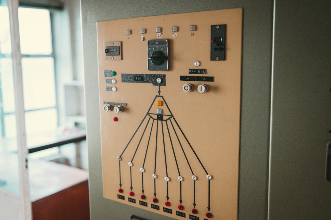 upgrade-or-replace-hardwired-alarm-old-panel - SIPKO Security An old alarm control panel with worn buttons, dials and indicator lights