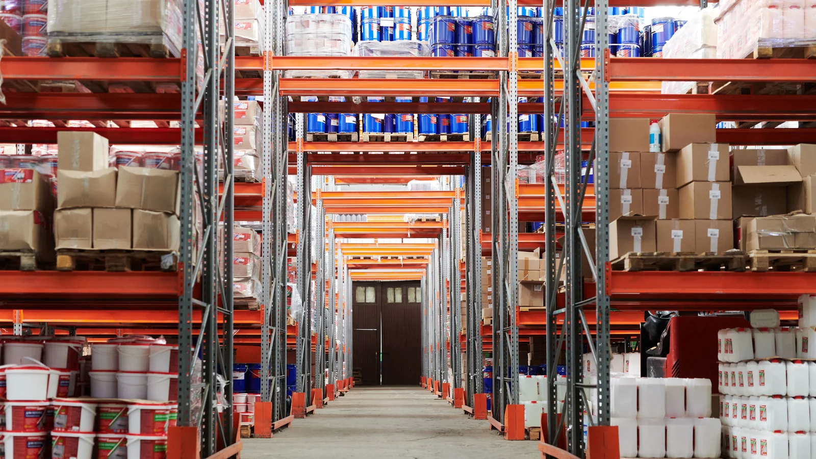 Warehouse aisle and pallet-rack coverage - SIPKO Security Warehouse aisle between pallet racks stocked with boxes and containers