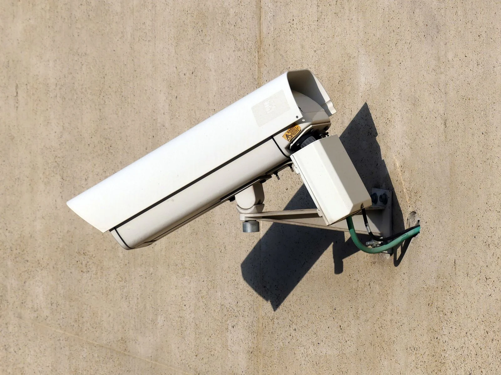 Budget guide - supporting photo 2 - SIPKO Security White security camera mounted on a beige exterior wall
