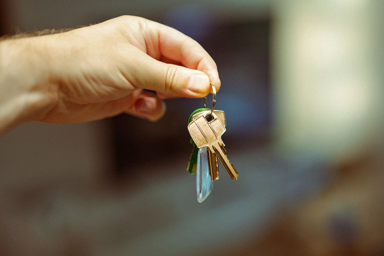 Hand holding a keyring with house keys