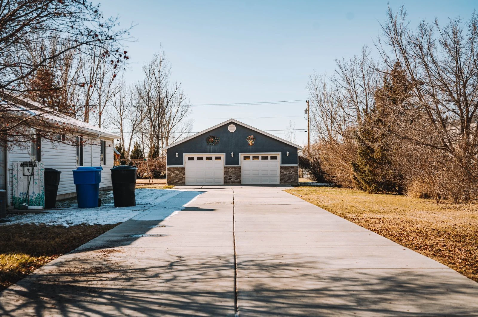 House frontage with a garage and driveway - SIPKO Security House frontage with a garage and driveway