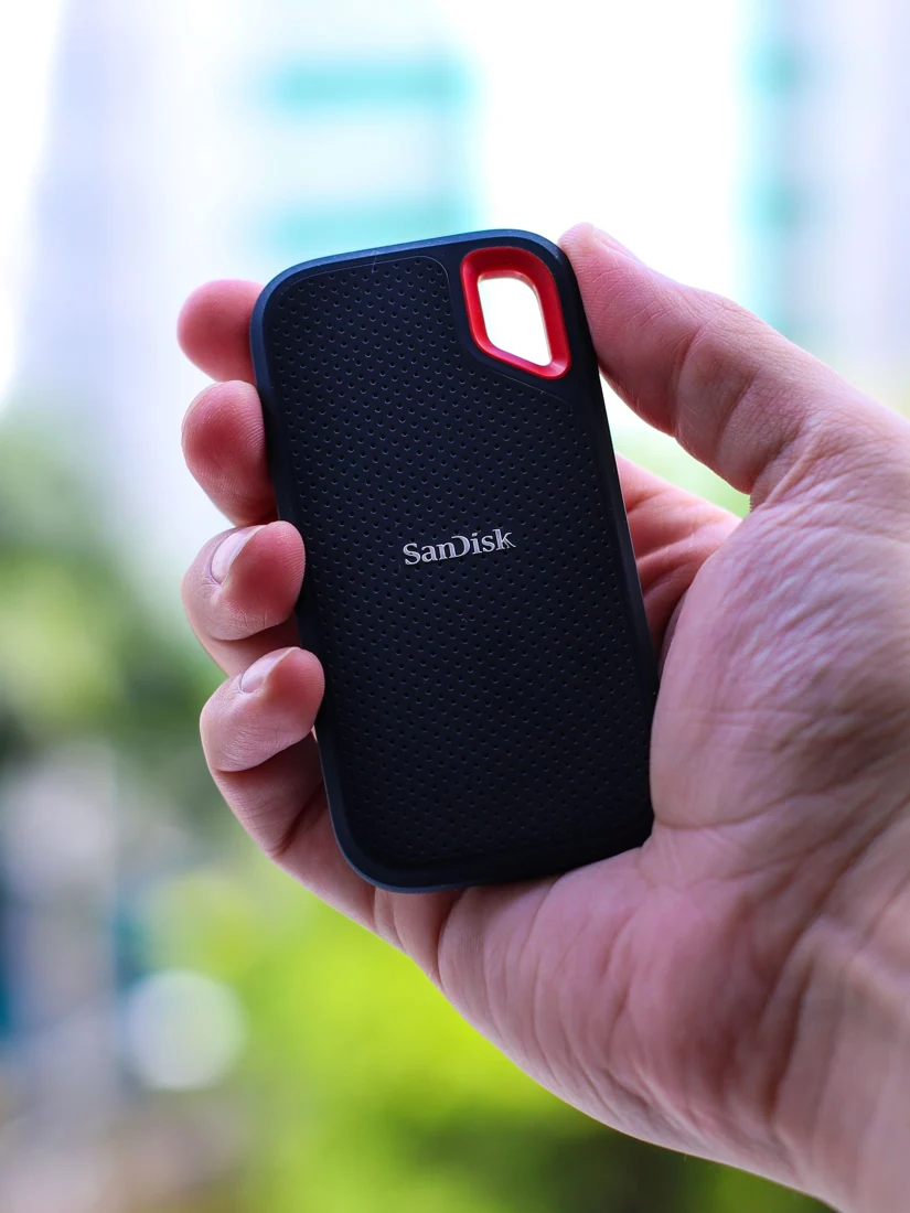 Hand holding a portable external storage drive - SIPKO Security Hand holding a portable external storage drive