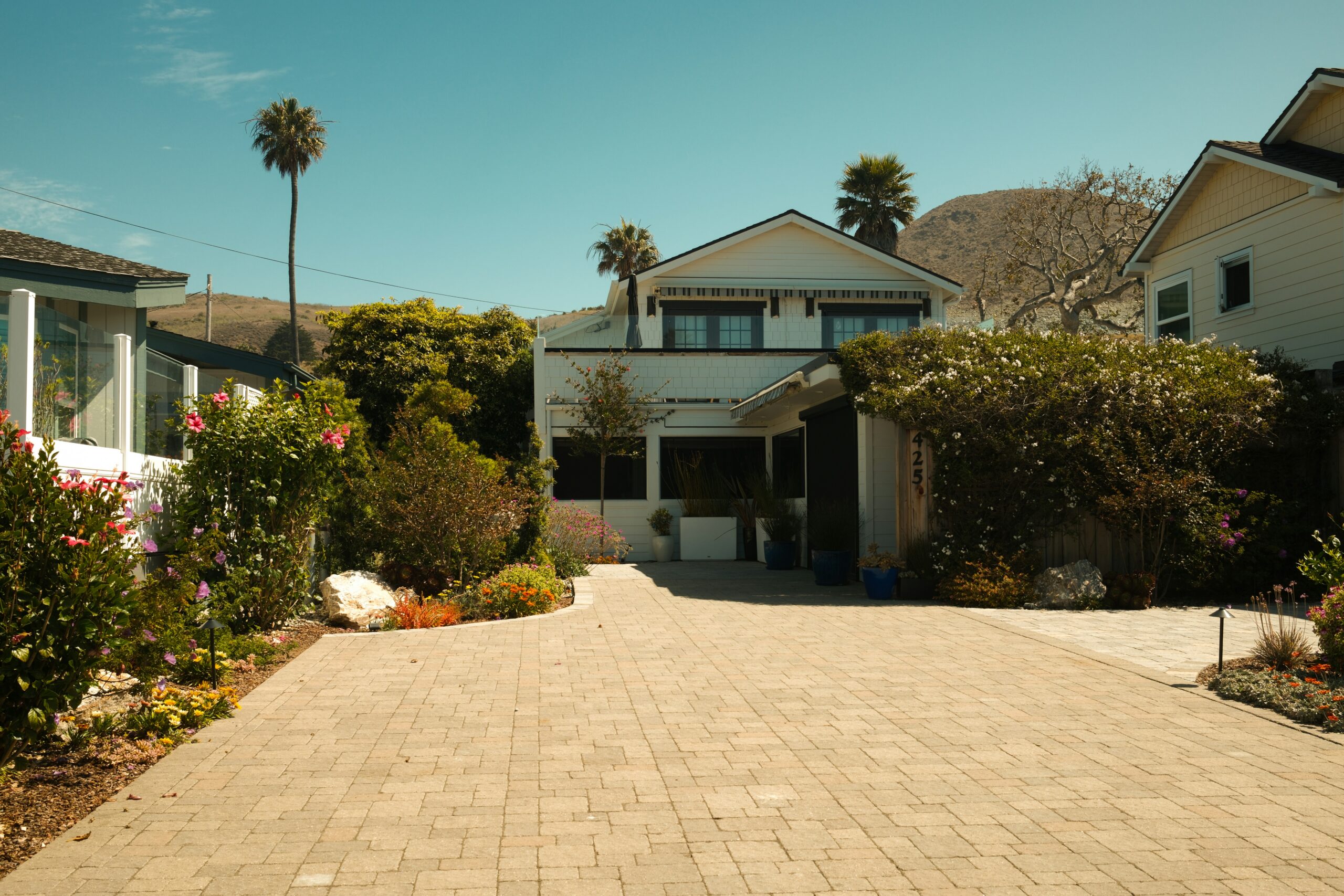 hikvision-6mp-vs-8mp-driveway-home - SIPKO Security Paved driveway leading to a two-storey home with garden landscaping
