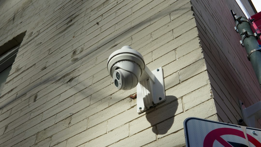 hikvision-acusense-vs-colorvu-security-camera-wall - SIPKO Security Close-up of a CCTV security camera mounted on an exterior brick wall
