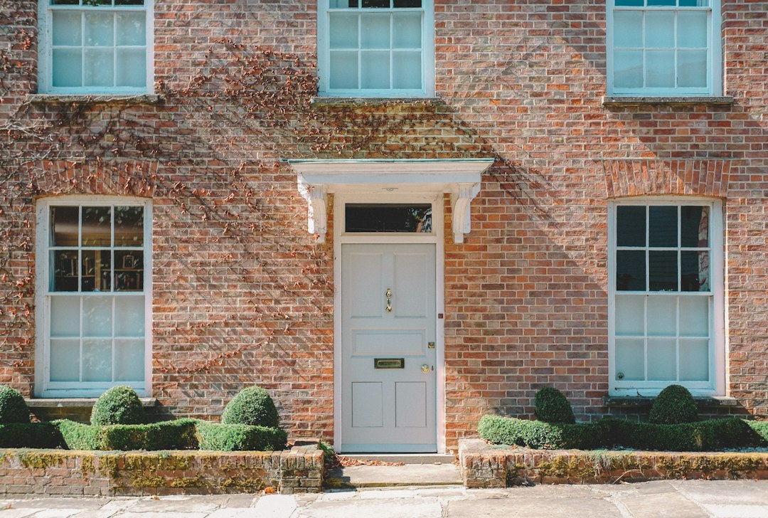 home alarm without wifi or internet - front door test - SIPKO Security Brick house front with a white wooden door