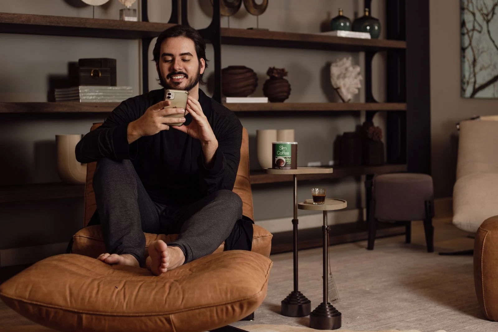 Man using a smartphone while sitting at home - SIPKO Security Man using a smartphone while sitting at home