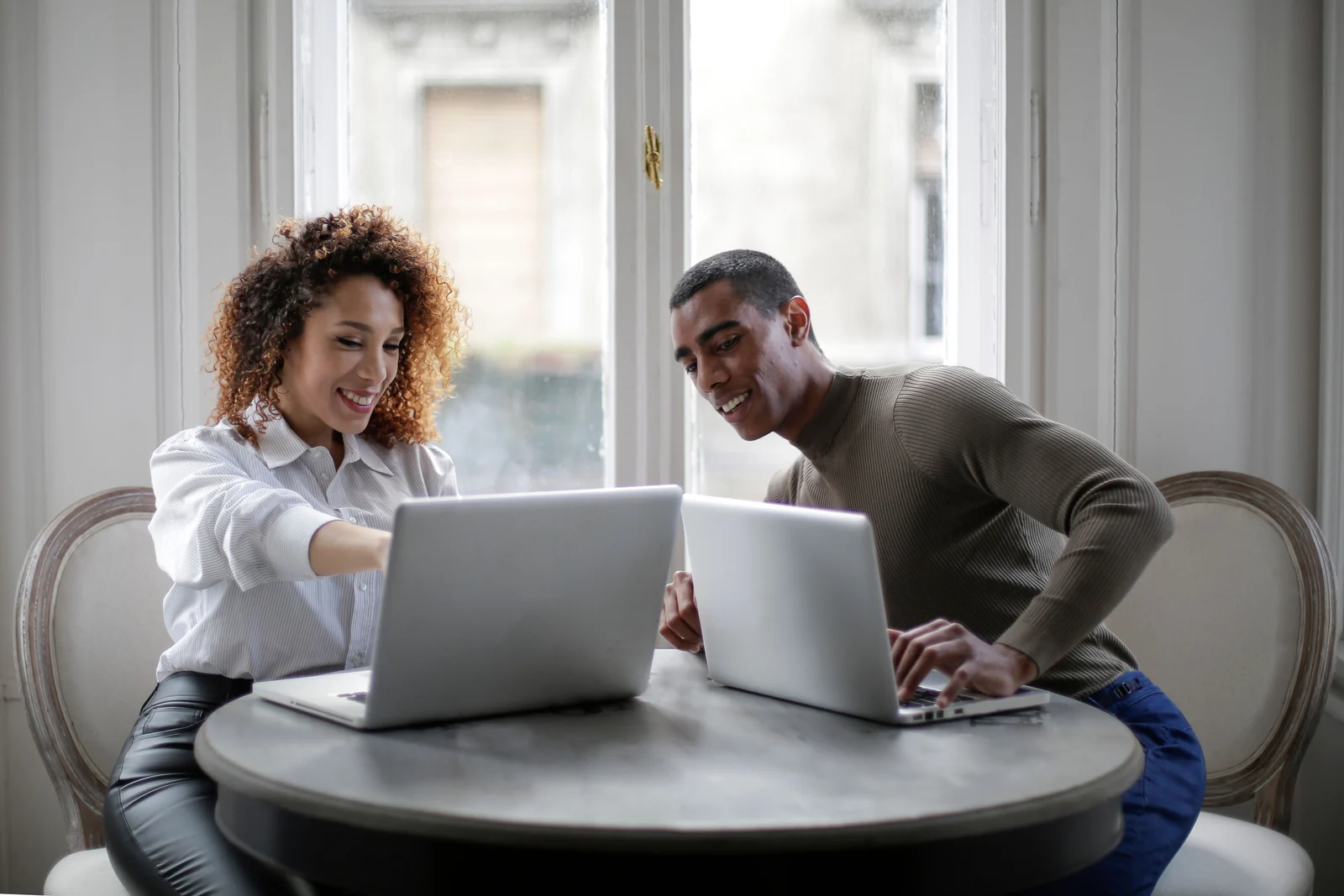 Reviewing digital access together - SIPKO Security Two adults reviewing a laptop screen together at a table by a window
