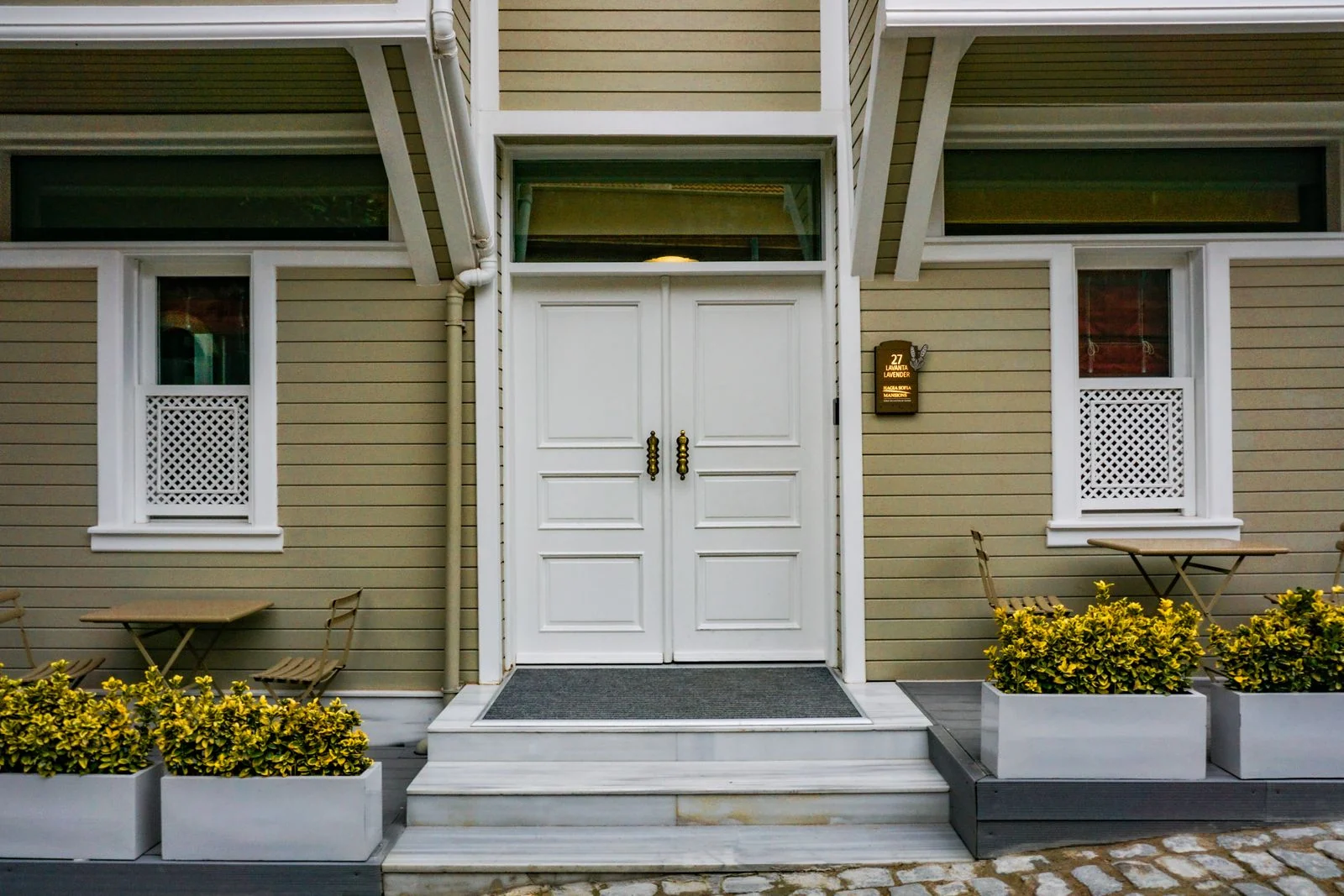 Suburb guide - supporting photo 2 - SIPKO Security House entrance with white double doors and potted plants